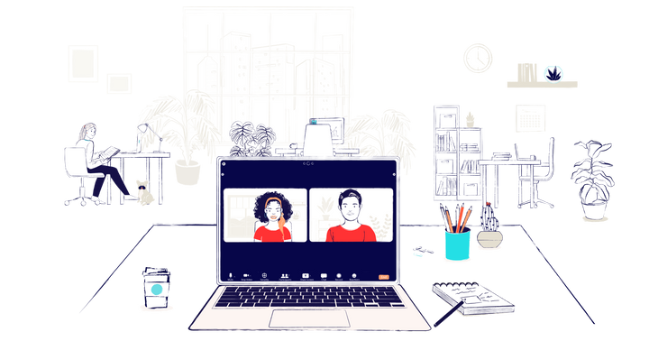 A desk with an open laptop. On the screen a virtual meeting is happening. A man and a woman, both wearing red, are on screen.