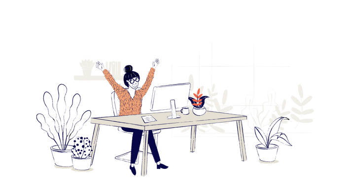 A woman sits at a desk celebrating a win, her arms are in the air and she is smiling